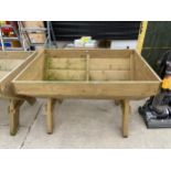 A LARGE WOODEN TROUGH PLANTER (120CM X 84CM X 79CM)