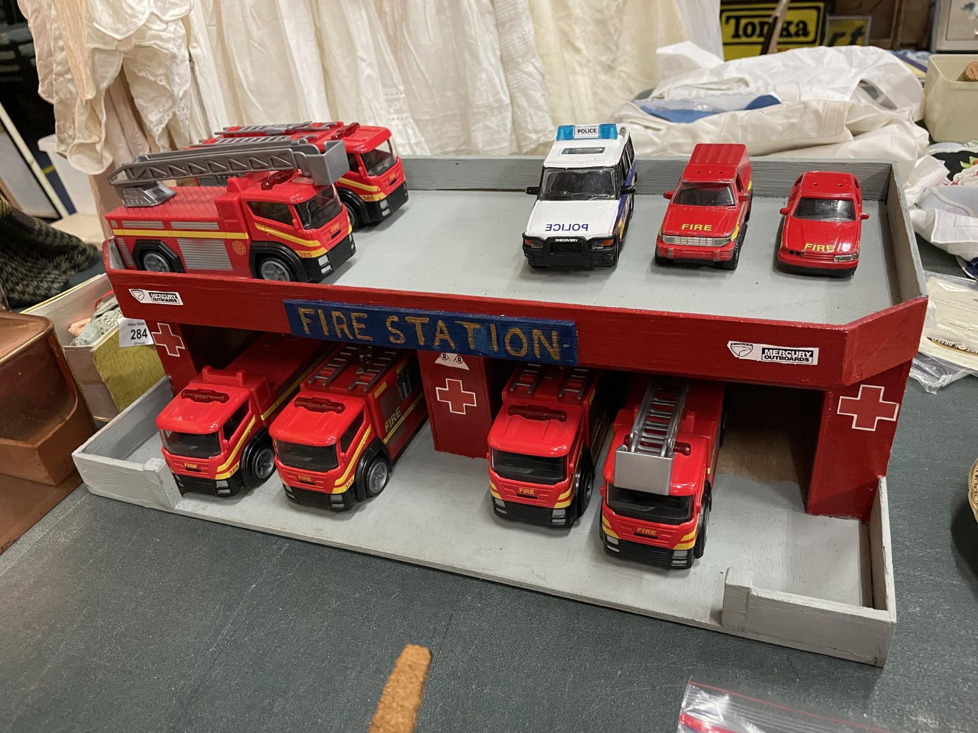 A WOODEN MODEL FIRE STATION WITH NINE VEHICLES