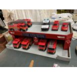 A WOODEN MODEL FIRE STATION WITH NINE VEHICLES