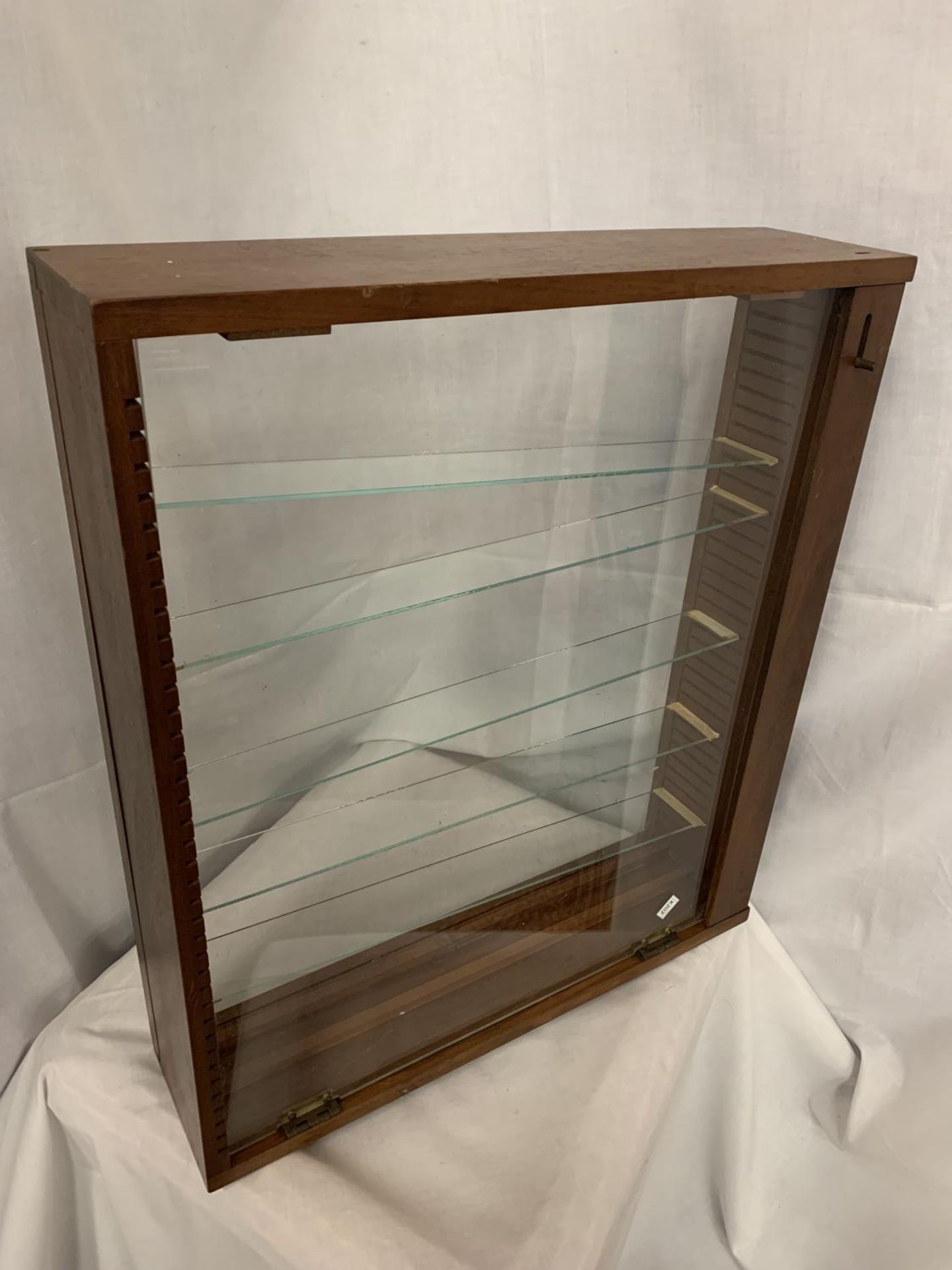 A WOODEN DISPLAY CABINET WITH ADJUSTABLE GLASS SHELVES