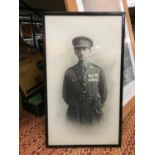 A FRAMED PICTURE OF A MILITARY MAN IN UNIFORM
