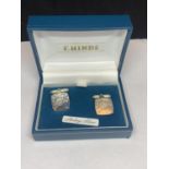 A PAIR OF SILVER CUFFLINKS IN A PRESENTATION BOX