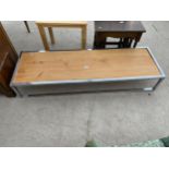 A PINE COFFEE TABLE ON CHROME SUPPORTS - 60" X 19"