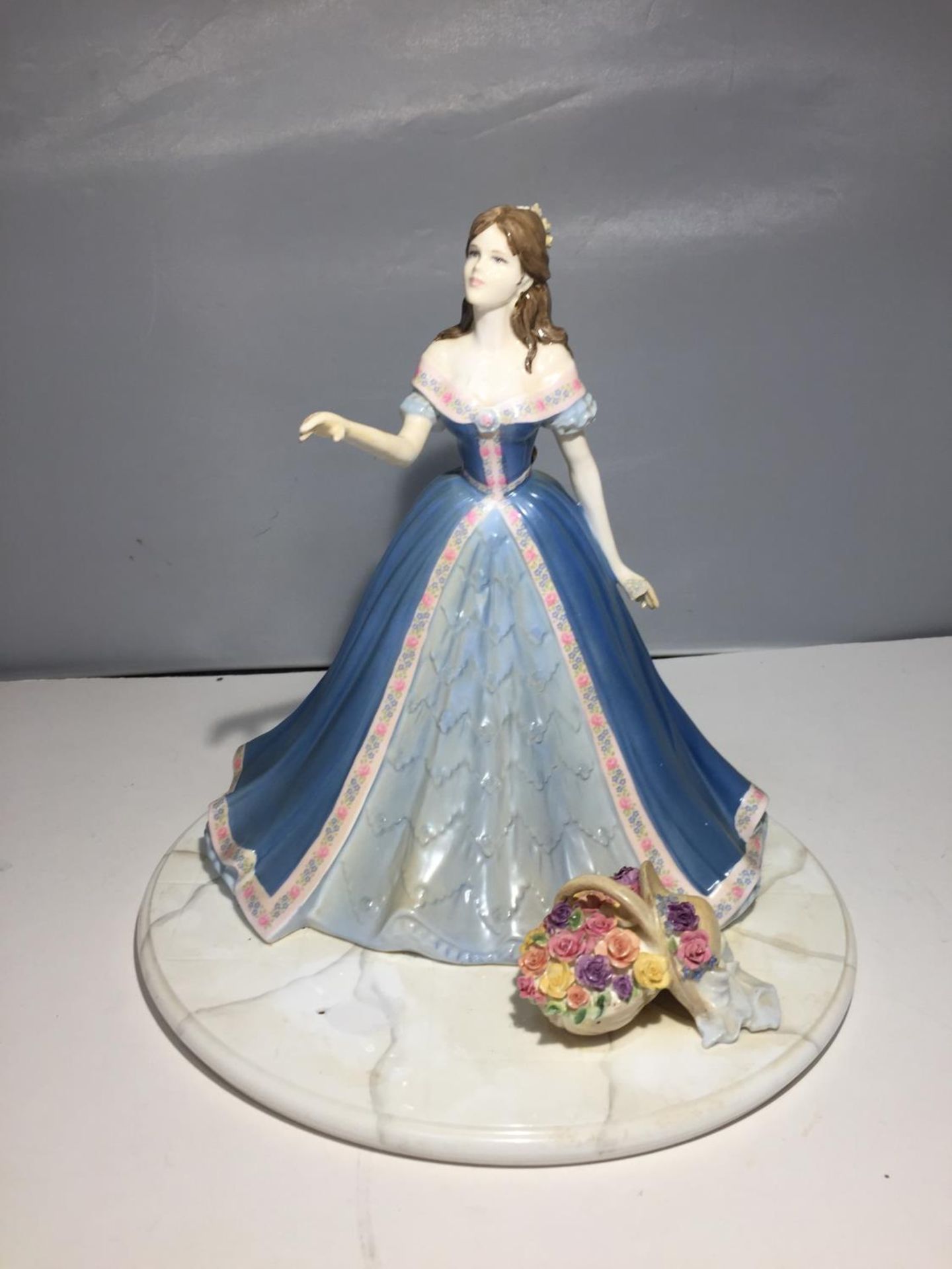 A COALPORT 'ROSE TERRACE' FIGURE 26CM TALL (A/F; MISSING THE JARDINAIRE AND FLOWERS THAT THE HAND IS
