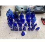 AN ASSORTMENT OF VARIOUS BLUE GLASS BOTTLES