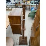 A HEAVILY CARVED TAPERING TEAK STANDARD LAMP WITH TIERED BASE