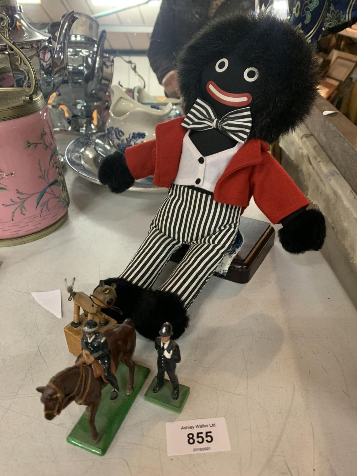 A ROBINSONS CHARACTER SOFT TOY AND TWO METAL FIGURES OF A POLICE MAN AND A POLICEMAN ON HORSEBACK