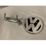 A METAL REPLICA OF A VW KEY FASHIONED INTO A KEY/COAT RACK