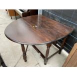 AN OVAL OAK GATE LEG DINING TABLE 57" X 42"