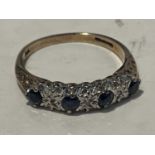 A 9 CARAT GOLD RING WITH THREE IN LINE DIAMOND AND FOUR SAPPHIRES IN A PRESENTATION BOX SIZE M/N