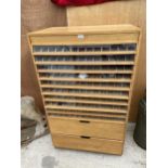 A VINTAGE MACHINIST'S HABERDASHERY CABINET ENCLOSING TWELVE VARIOUS SECTIONAL DRAWERS