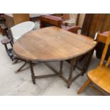 AN EARLY 20TH CENTURY OVAL OAK GATE LEG DINING TABLE ON BARLEY TWIST SUPPORTS