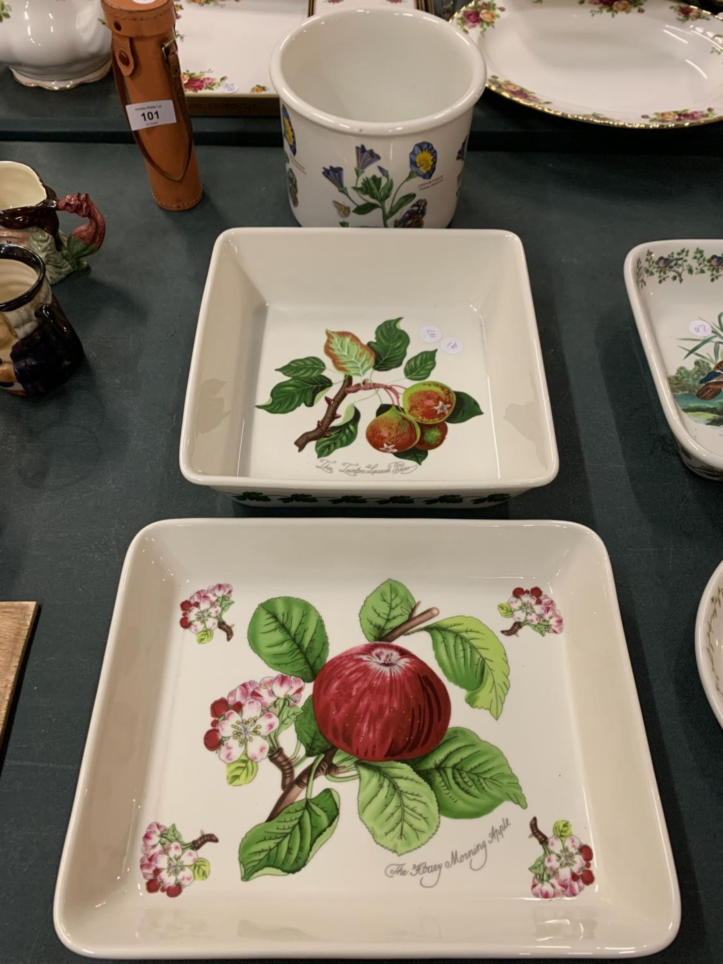 THREE PORTMERION DISHES DECORATED WITH FLORAL THEMES