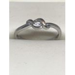 A 9 CARAT WHITE GOLD SOLITAIRE RING WITH PRESENTATION BOX