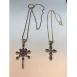 TWO MARKED SILVER NECKLACES WITH HEAVY 925 CROSSES WITH RED STONE DECORATION ONE CHAIN LENGTH 60