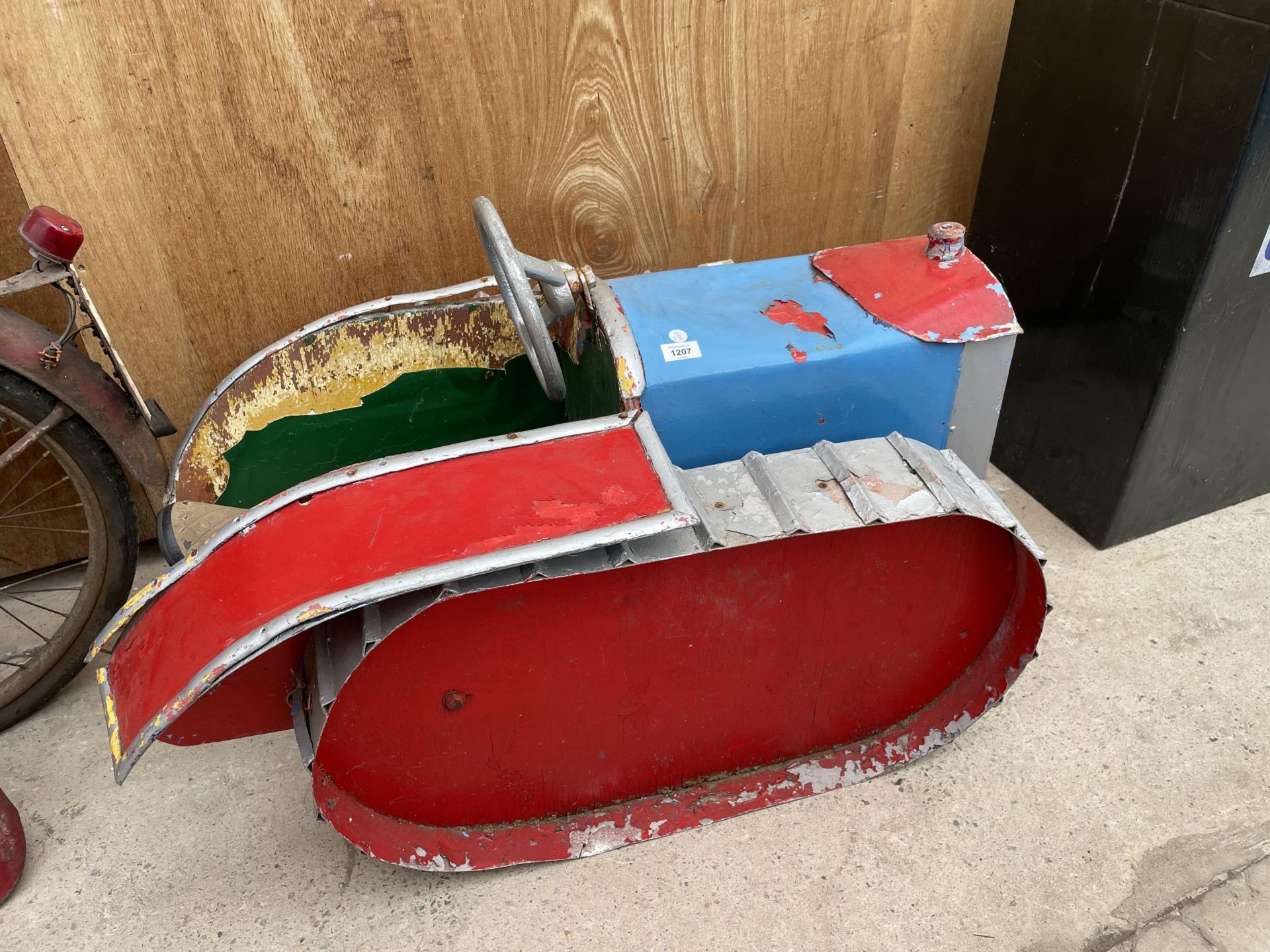 A VINTAGE CHILDRENS TRACTOR FAIRGROUND RIDE