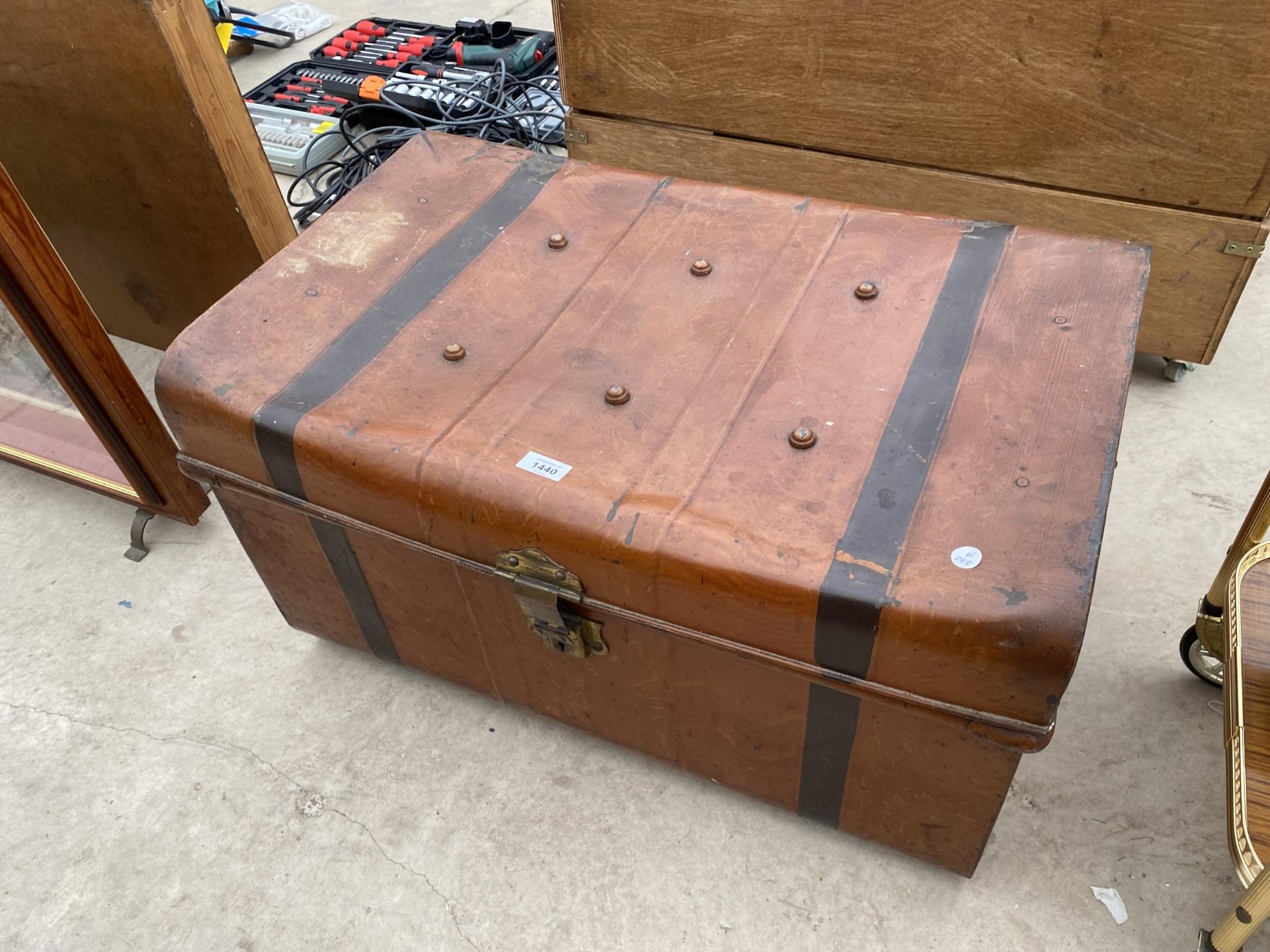 A VINTAGE METAL STORAGE TRUNK WITH TWO HANDLES AND CLASP