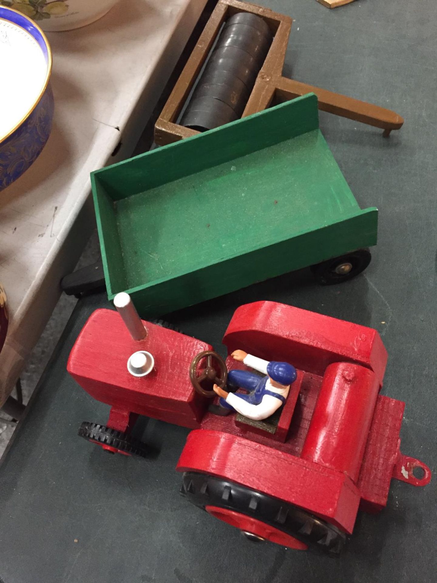 A WOODEN MODEL OF A FARM TRACTOR TOGETHER WITH ATTACHABLE TRAILER AND FIELD ROLLER