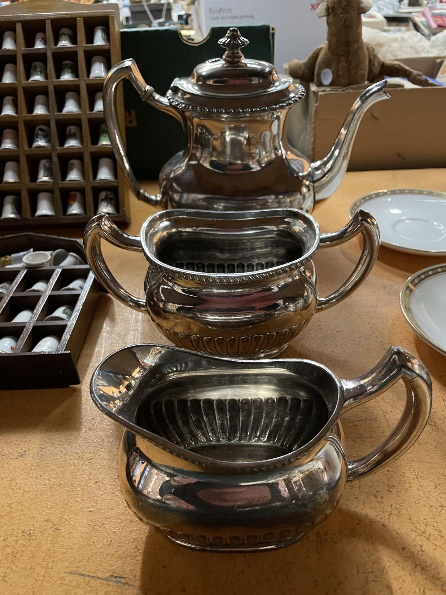 A THREE PART SILVER PLATED SET TO INCLUDE A TEAPOT, SUGAR BOWL AND MILK JUG