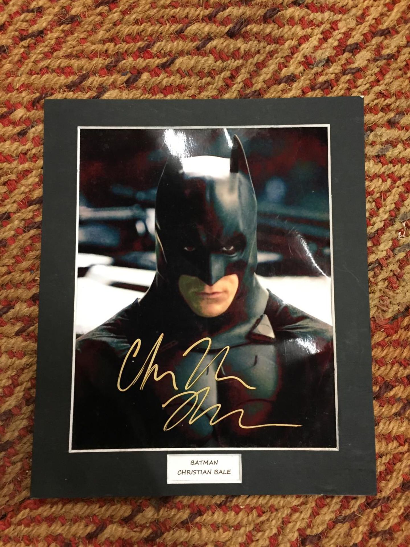 A MOUNTED SIGNED PICTURE OF CHRISTIAN BALE PLAYING BATMAN