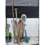 AN ASSORTMENT OF GARDEN TOOLS TO INCLUDE SHOVELS, GARDEN SHEARS AND A BLACK AND DECKER STRIMMER ETC