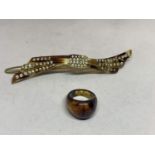 A TORTOISE SHELL HAIR SLIDE WITH CLEAR STONE DECORATION AND A MATCHING RING