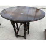 AN EARLY 20TH CENTURY OVAL OAK BARLEY-TWIST GATE-LEG TABLE 40 INCHES X 29 INCHES OPEN