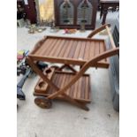 A TEAK TWO TIERED TROLLEY WITH REMOVABLE TRAY AND LOWER BOTTLE HOLDER