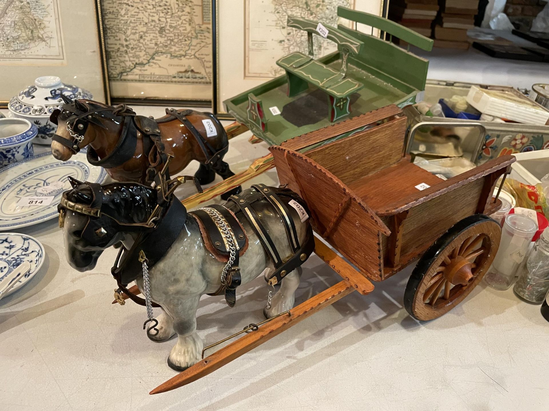 TWO CERAMIC HORSES WITH WOODEN CARTS