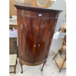 A GEORGE III MAHOGANY BOW FRONT CORNER CABINET ON CABRIOLE SUPPORTS