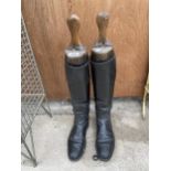 A PAIR OF LEATHER RIDING BOOTS WITH FOUR SECTION WOODEN STRETCHERS STAMPED 'F. WATTS'