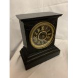 A HEAVY BLACK METAL MANTLE CLOCK WITH GILT ROMAN NUMERALS AND FACE SURROUND