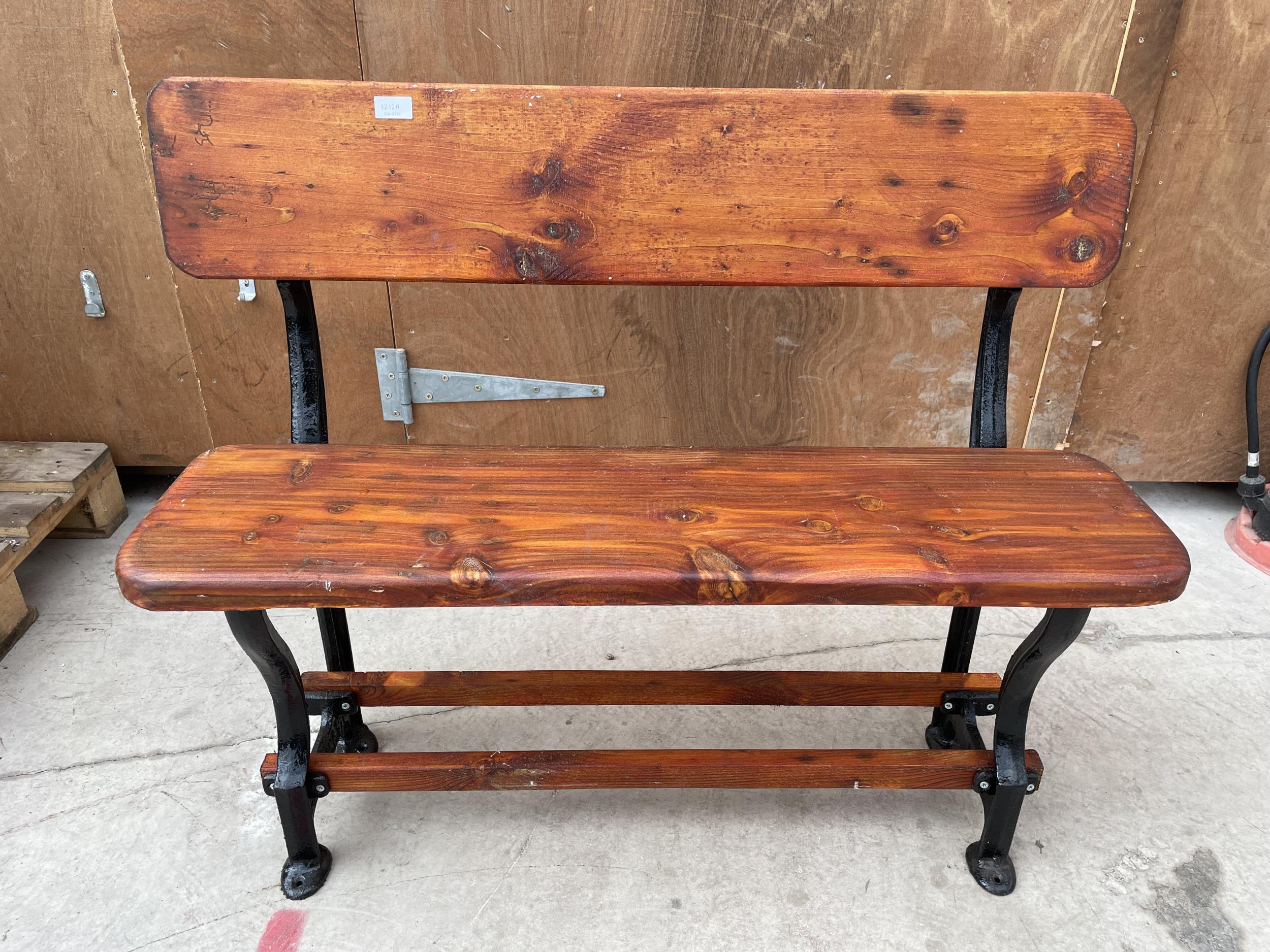 A VINTAGE WOODEN TRAM BENCH WITH CAST ENDS (L:105CM)