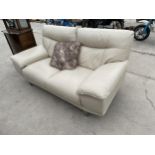 A MODERN WHITE LEATHER TWO SEATER SETTEE ON CHROME LEGS