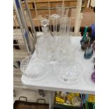 AN ASSORTMENT OF GLASS WARE TO INCLUDE CUT GLASS DECANTORS, VASES AND A TRIFLE BOWL ETC