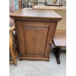 A MID 20TH CENTURY OAK BEDSIDE LOCKER WITH PANNELED DOOR