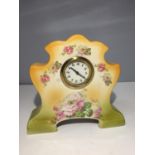 A DECORATIVE CERAMIC MANTLE CLOCK WITH A DELICATE ROSE DESIGN