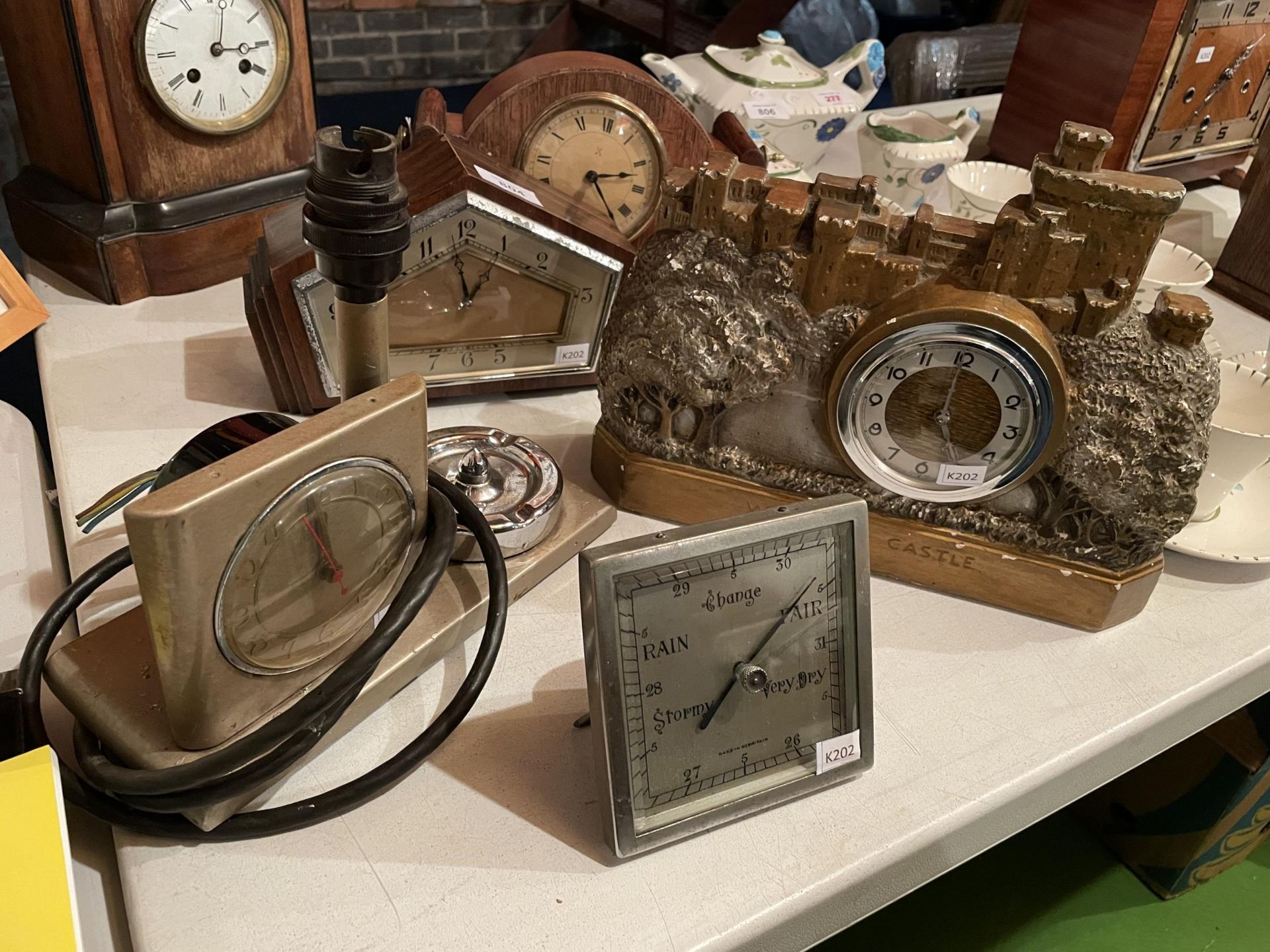 A BAROMETER, A LAMP, CLOCK AND ASHTRAY ALL IN ONE AND A CLOCK IN THE SHAPE OF WINDSOR CASTLE