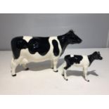 A BESWICK FRESIAN COW AND A BESWICK FRESIAN CALF