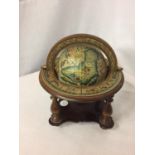 A SMALL WOODEN GLOBE ON A BASE HEIGHT APPROX 8 INCHES