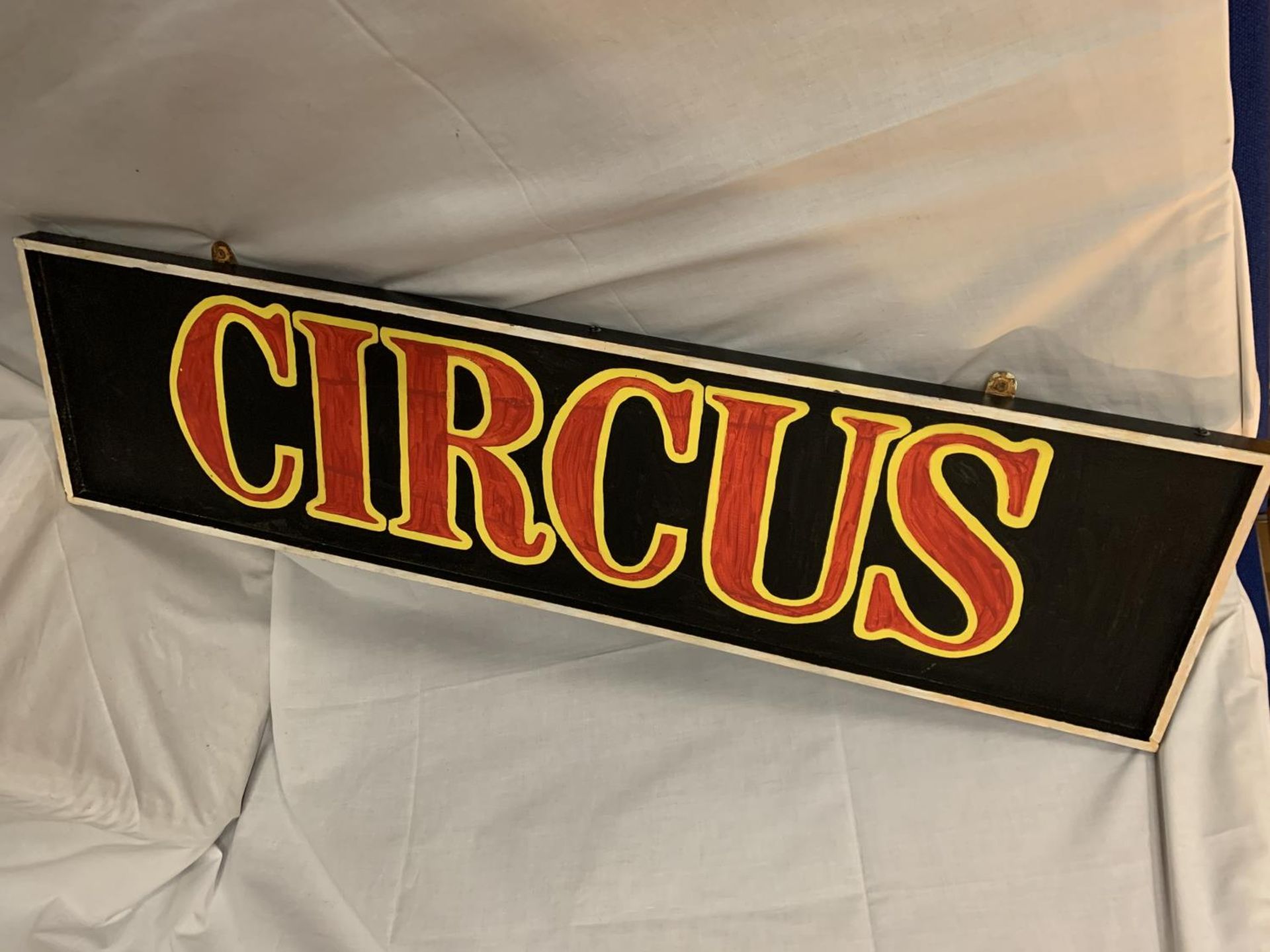A PAINTED WOODEN CIRCUS SIGN 32CM X 124CM