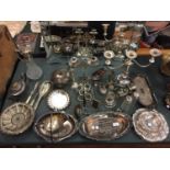 A LARGE COLLECTION OF SILVER PLATE TO INCLUDE PLATTERS, CANDLESTICKS, TEAPOT, NAPKIN RINGS ETC
