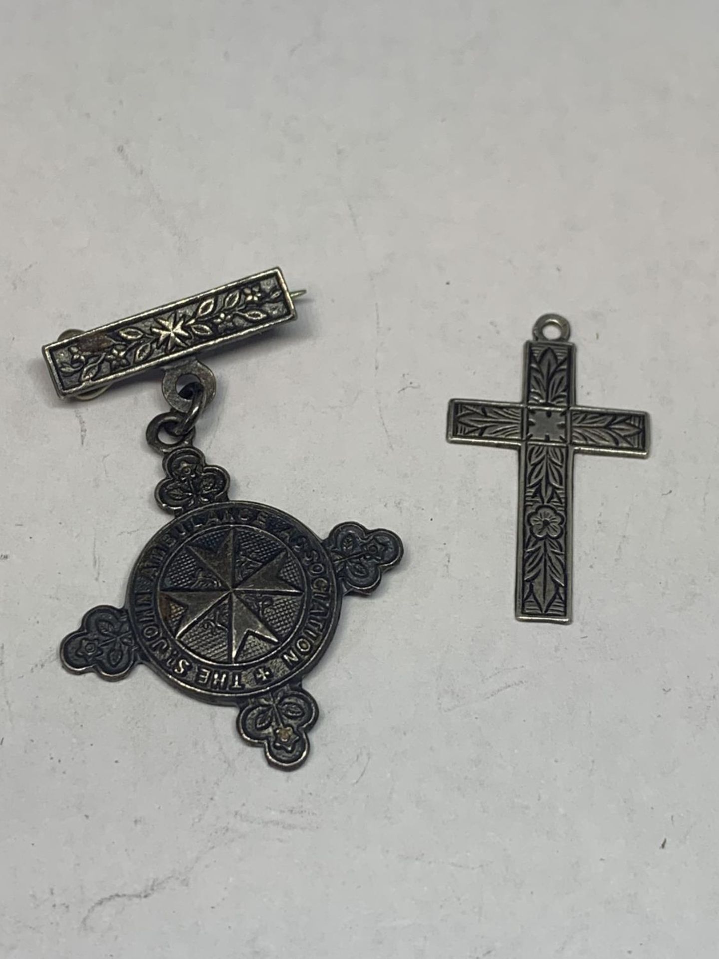 A MARKED SILVER CROSS AND A HALLMARKED ST JOHNS AMBULANCE MEDAL