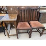 AN EARLY 20TH CENTURY OAK SIDE TABLE WITH BARLEY TWIST SUPPORTS AND TWO OAK DINING CHAIRS