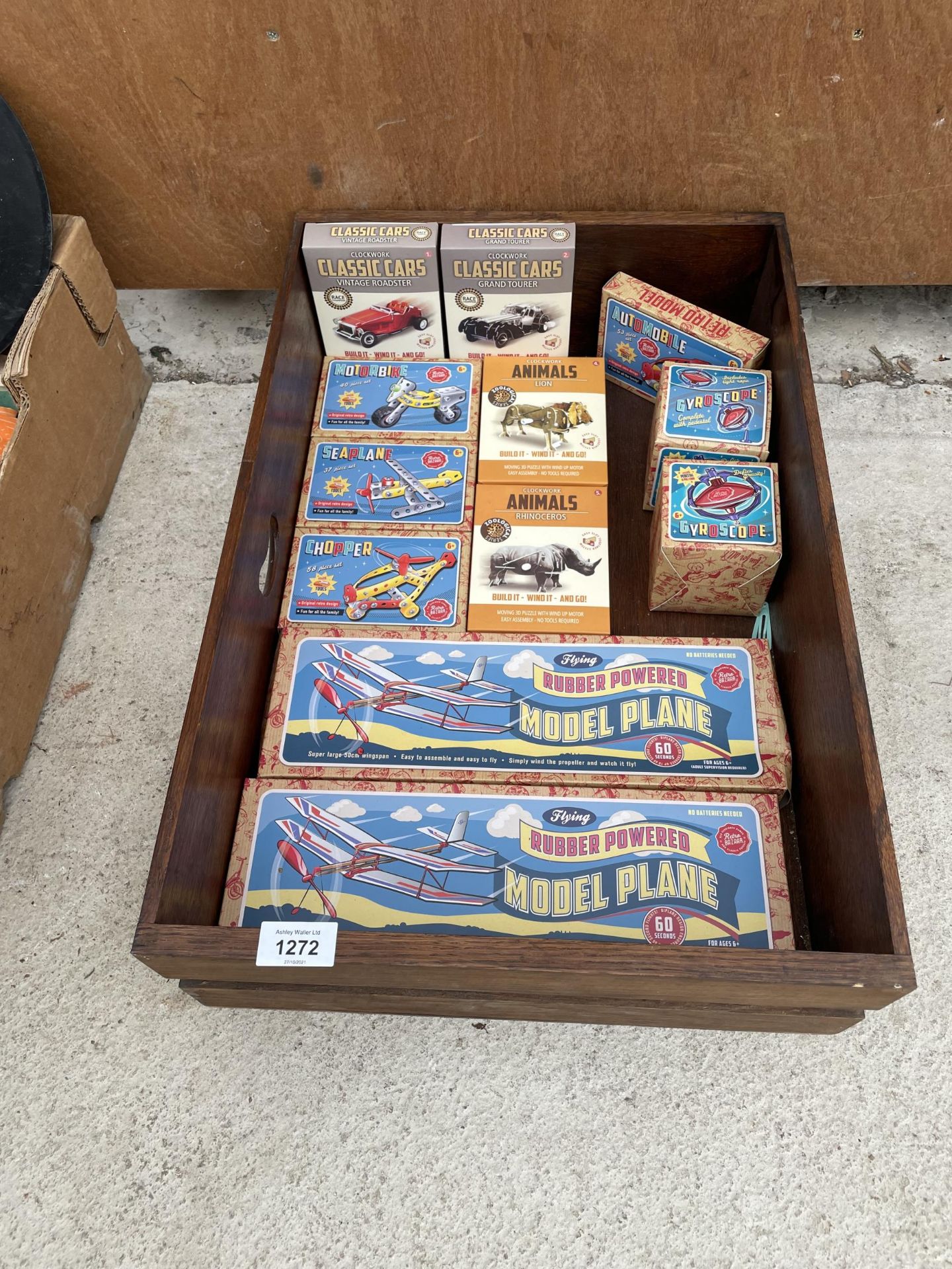 A WOODEN STORAGE CHEST CONTAINING AN ASSORTMENT OF RETRO CHILDRENS GAMES