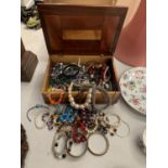 A LARGE COLLECTION OF COSTUME JEWELLERY IN A WOODEN BOX