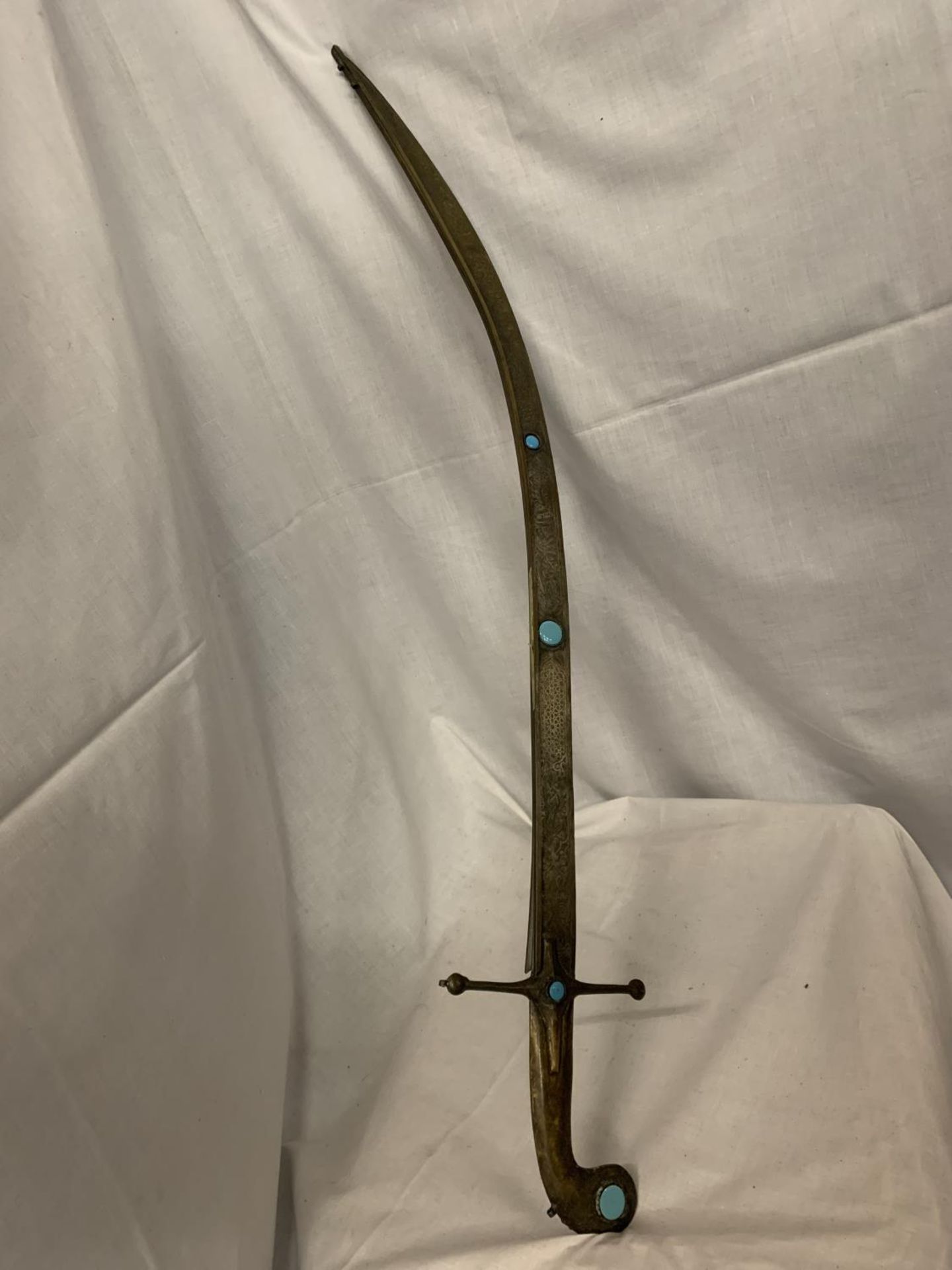 AN ANTIQUE BRASS SWORD WITH TURQUOISE STONE DECORATION