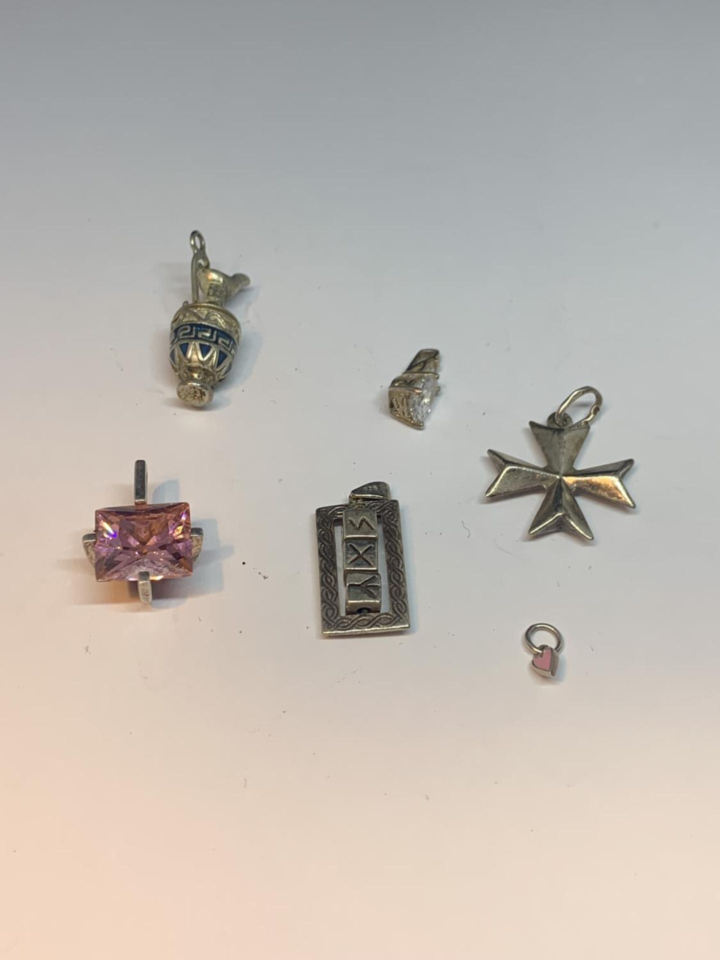 SIX SILVER PENDANTS TO INCLUDE A PINK STONE, MALTESE CROSS, EWER, CLEAR STONE ETC