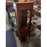 AN EDWARDIAN STYLE SHELL INLAID GLAZED SINGLE DOOR CABINET ON BASE INCLUDING TWO SHORT AND ONE