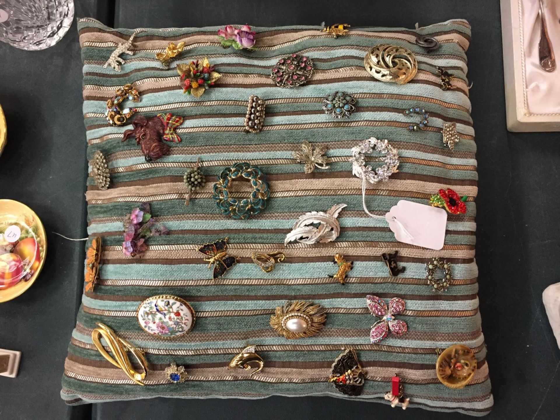 A CUSHION OF BROOCHES